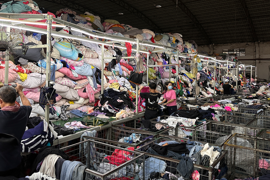 Textile sorting warehouse with clothing bins Belofy